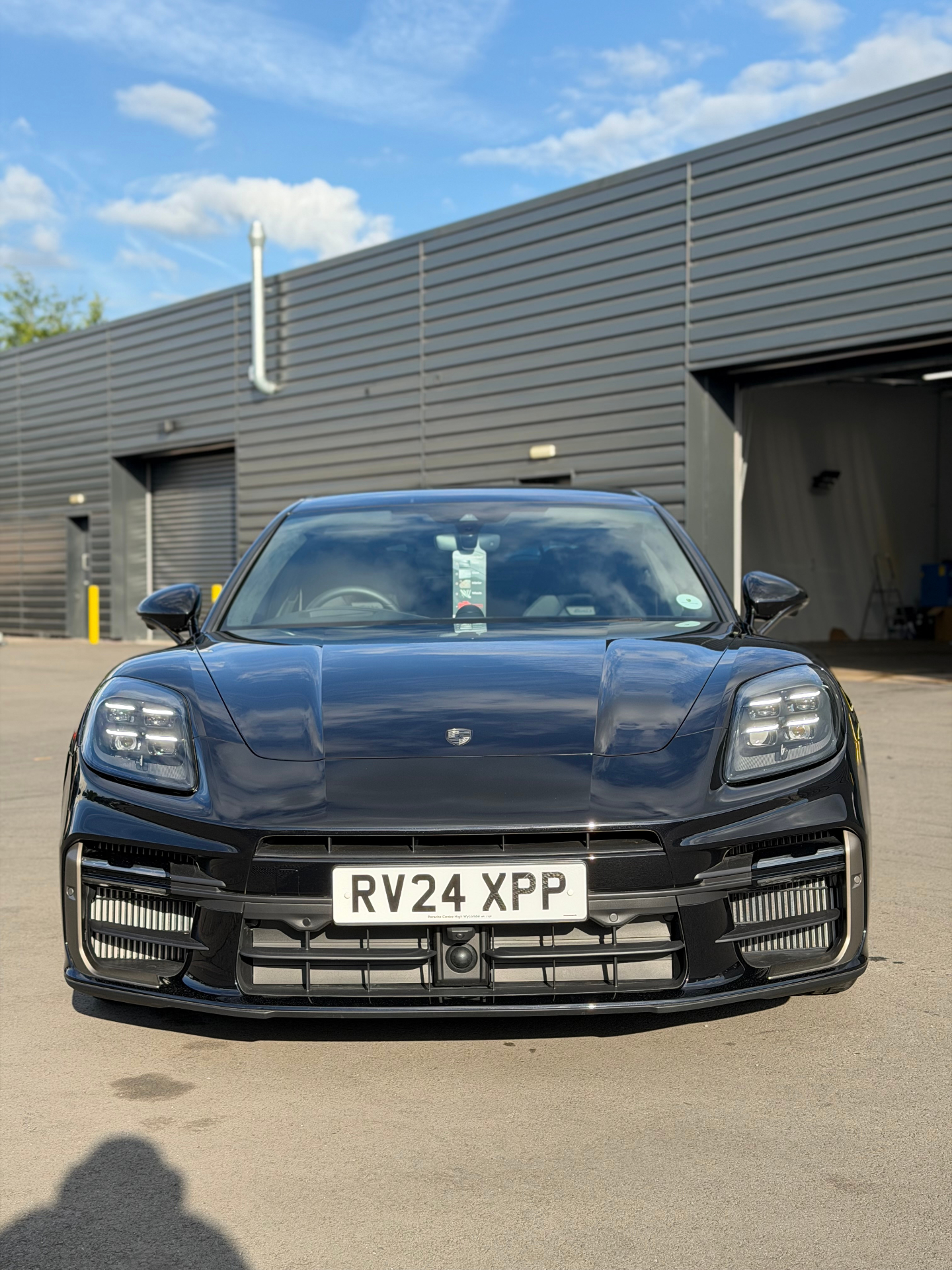 Black Porsche Panamera front view outside studio
