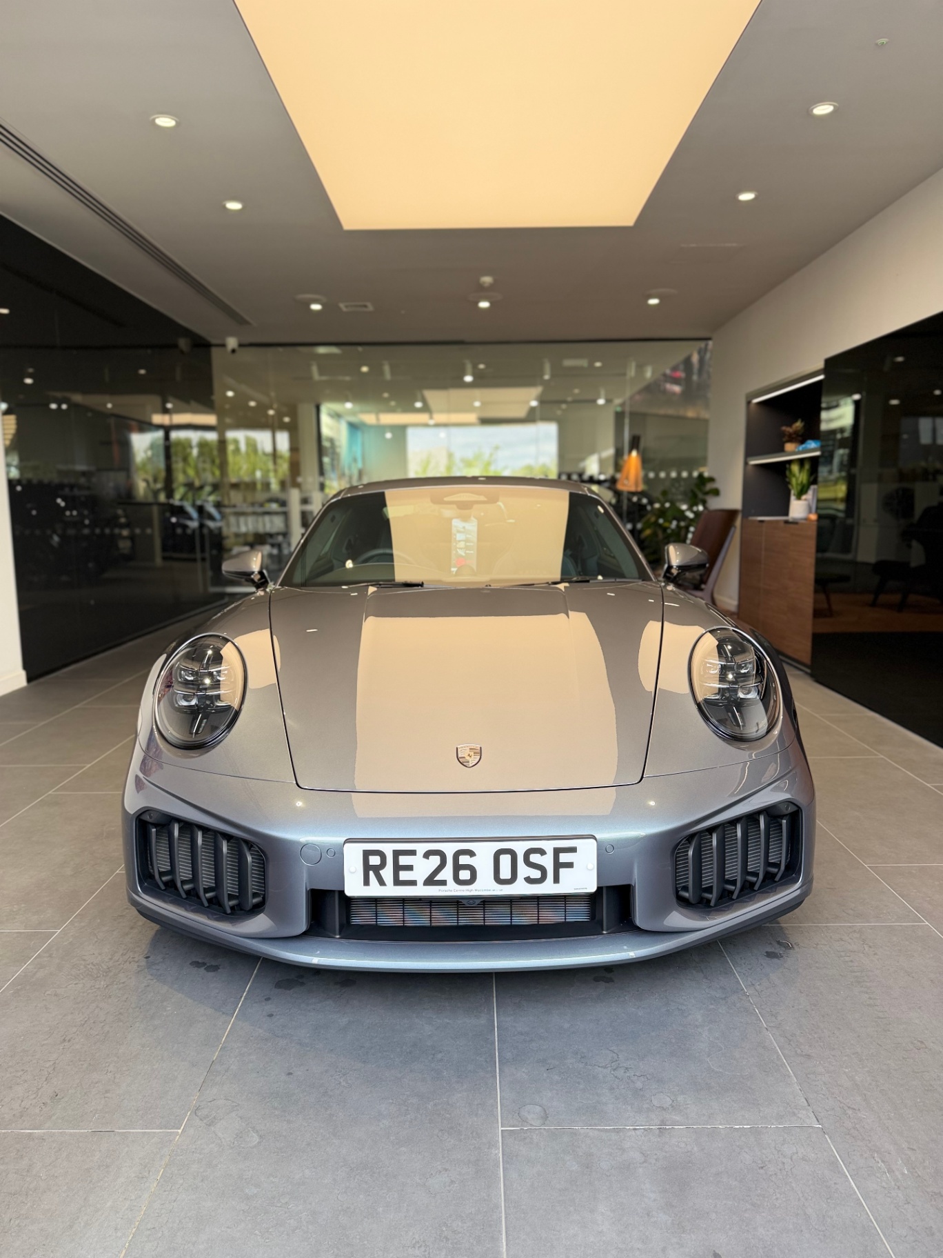 Grey Porsche 911 front view inside showroom
