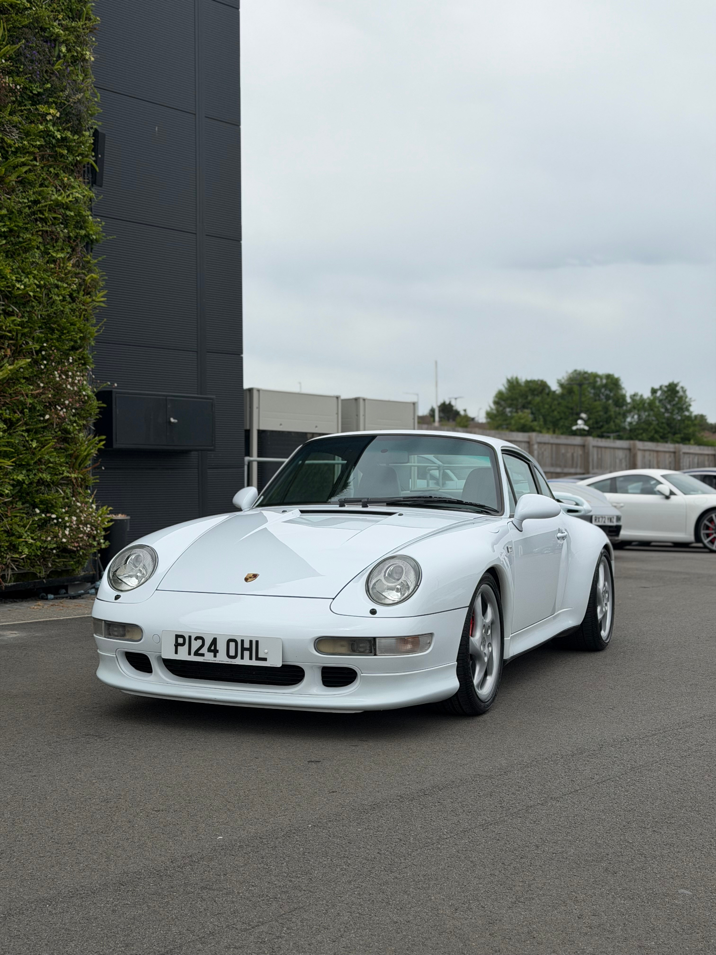 White Porsche 911 parked outside detailing studio