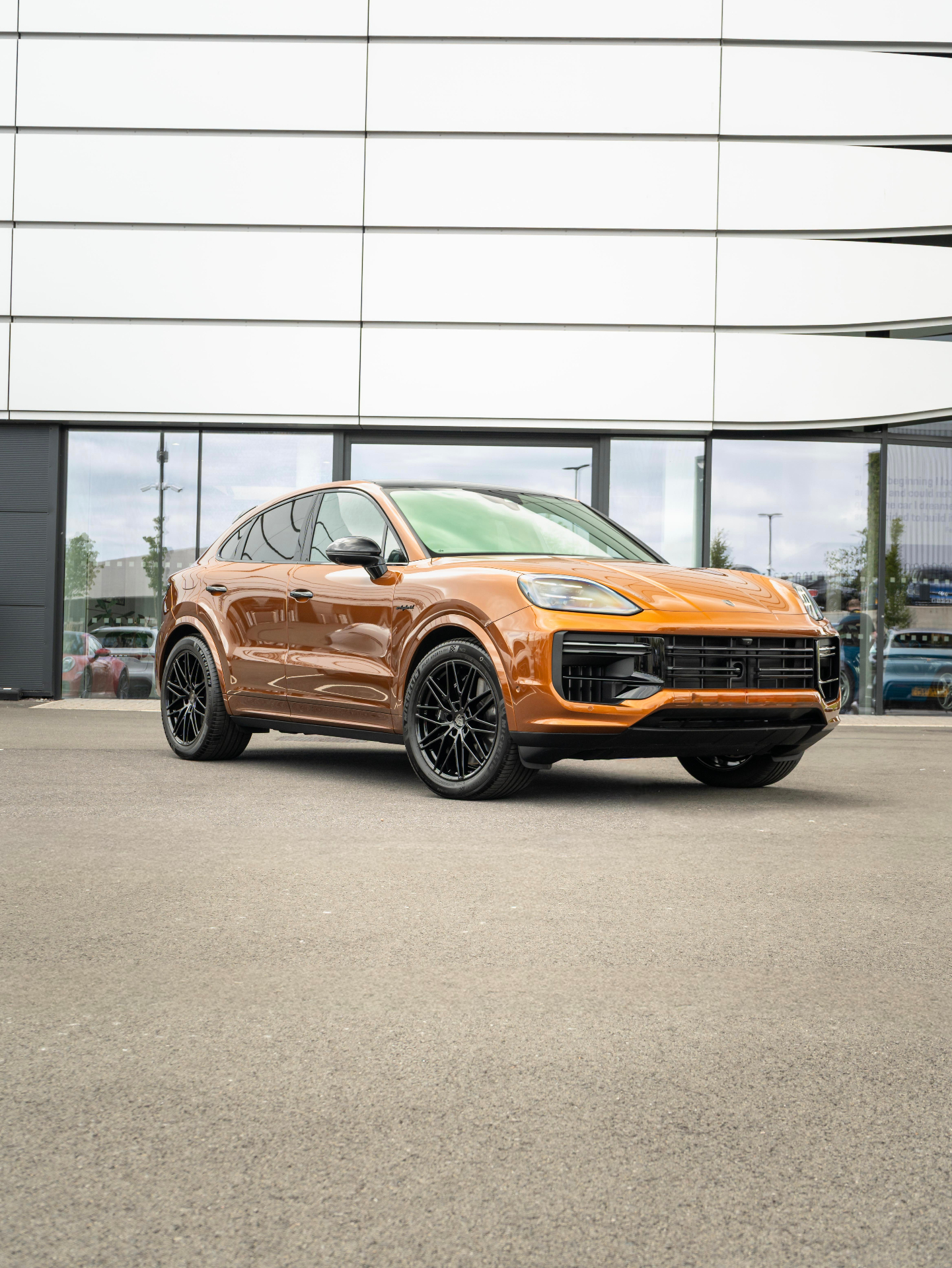 Orange Porsche Cayenne Coupe E-Hybrid front three-quarter view