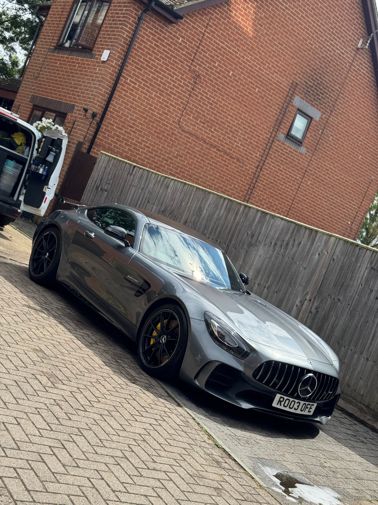 Grey Mercedes-AMG GT parked driveway view